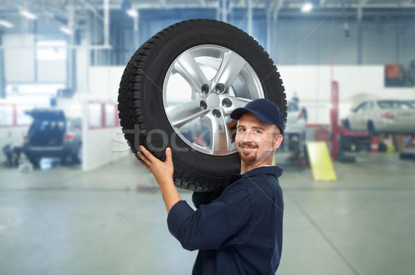 Car mechanic with a tire . Stock photo © Kurhan