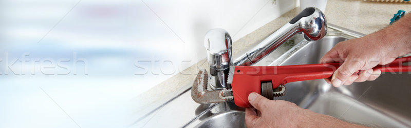 Plumber with wrench. Stock photo © Kurhan