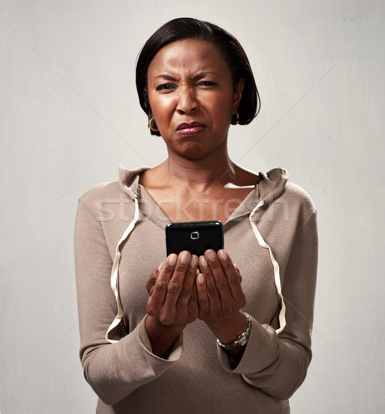 discontented woman with smartphone Stock photo © Kurhan