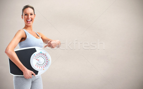 Woman with scales over gray background. Stock photo © Kurhan