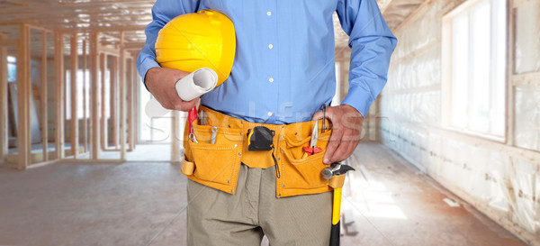 Construction worker with helmet and tool belt. Stock photo © Kurhan