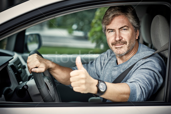 Man driving car with thumb. Stock photo © Kurhan