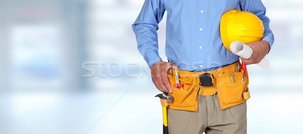 Construction worker with helmet and tool belt. Stock photo © Kurhan