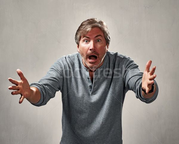 Crítico enojado hombre retrato gris pared Foto stock © Kurhan