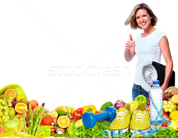 Beautiful fitness girl with scales and vegetables. Stock photo © Kurhan