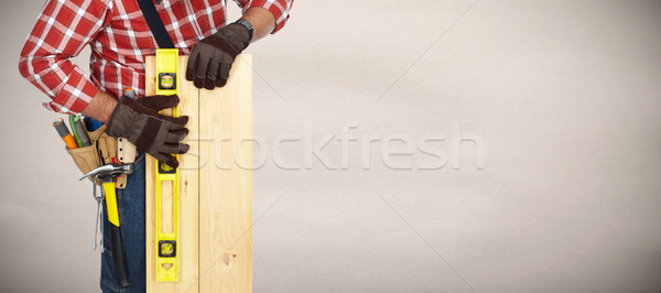 Builder with level and wooden planks. Stock photo © Kurhan