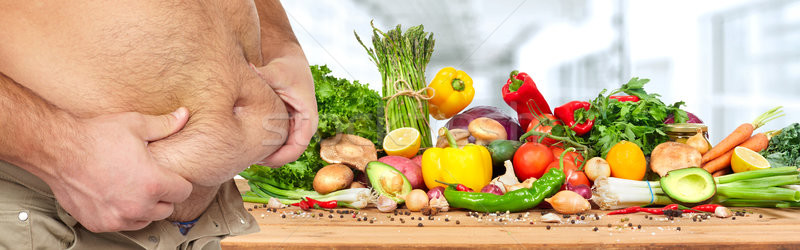 Otyłość zdrowa żywność grubas duży brzuch warzyw Zdjęcia stock © Kurhan