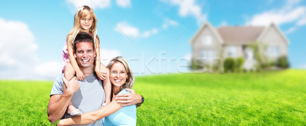Happy family near new house. Stock photo © Kurhan