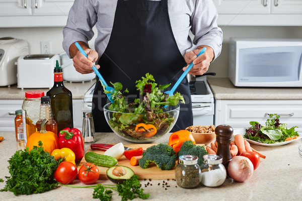 Chef man cooking in the kitchen. Stock photo © Kurhan