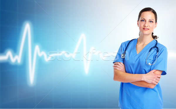 Stock photo: Medical doctor woman. Over cardio background.