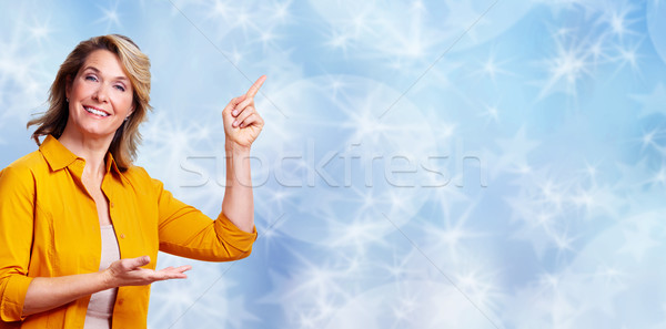 Beautiful senior woman presenting copy space. Stock photo © Kurhan