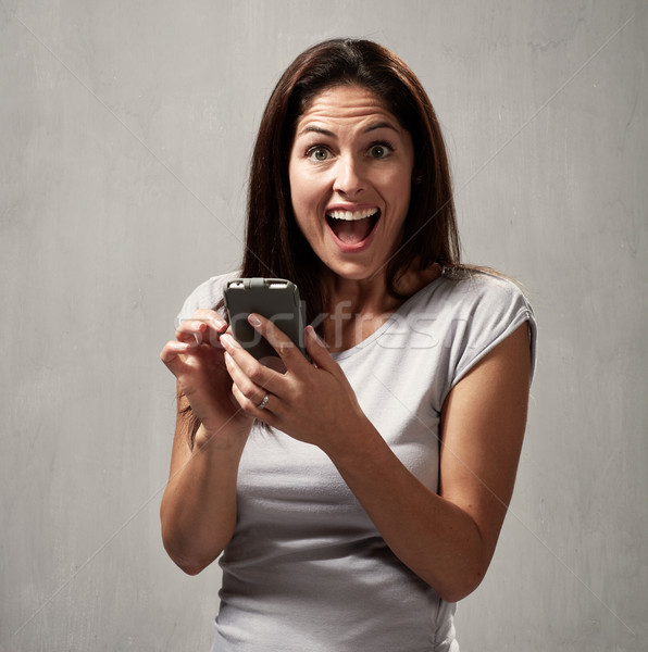 Stock photo: Happy girl with cell phone