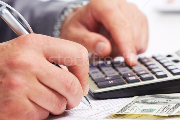 Hands of businessman with calculator. Stock photo © Kurhan