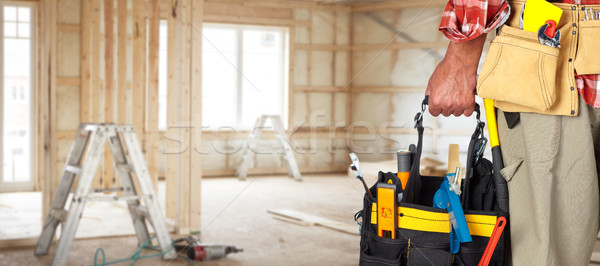 Hand of handyman with a tool bag. Stock photo © Kurhan