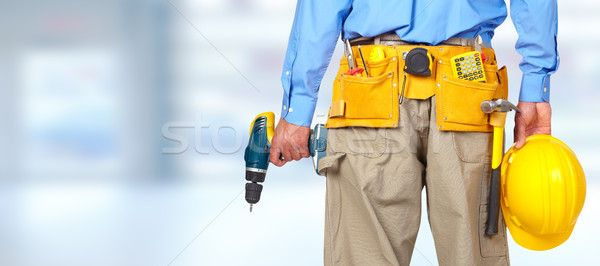 Construction worker with helmet and drill. Stock photo © Kurhan