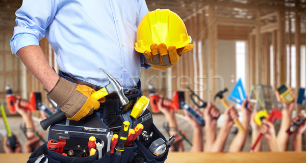 Construction worker with hammer and tools. Stock photo © Kurhan