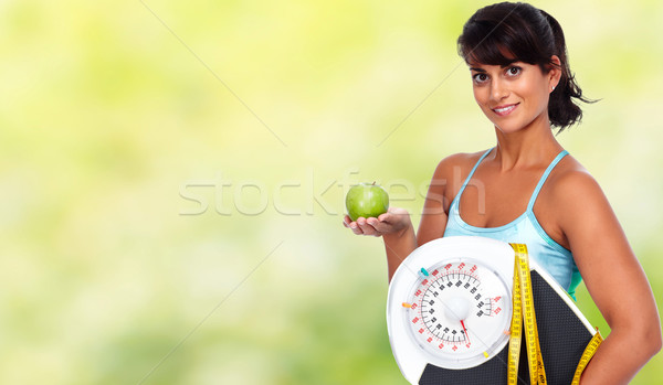 Young asian woman with apple and scales. Stock photo © Kurhan