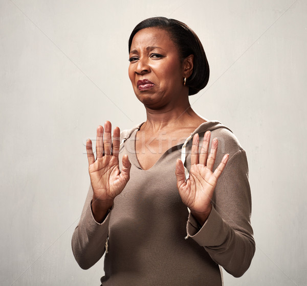 Undor afroamerikai nő gusztustalan arc kéz Stock fotó © Kurhan
