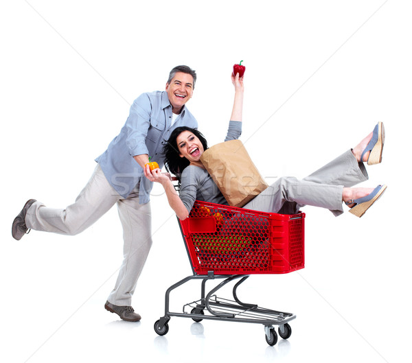 Happy couple with a grocery shopping cart. Stock photo © Kurhan