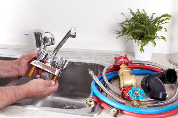 Plumber with a water tap. Stock photo © Kurhan