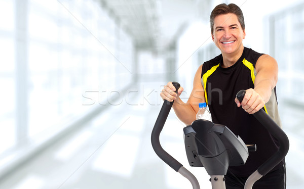 Man exercising on elliptical trainer. Stock photo © Kurhan