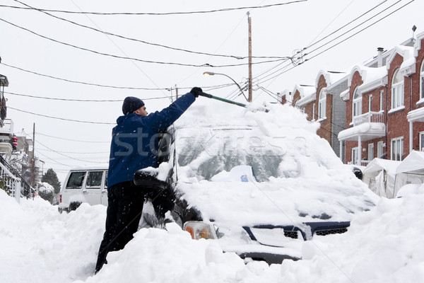 Man with a snow shovel. Snowfall in the city. Stock photo © Kurhan