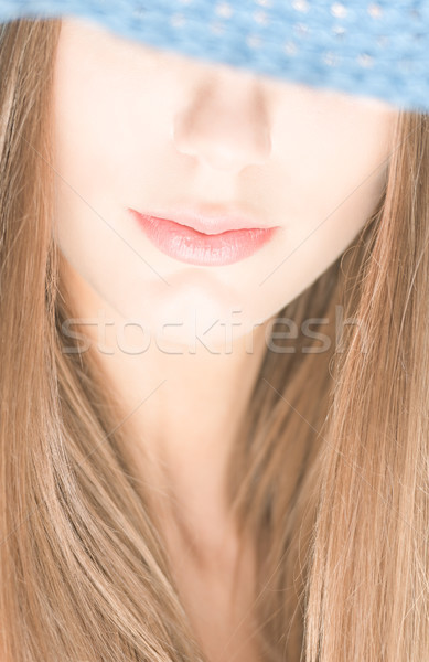 Young woman with half hidden face under blue hat. Stock photo © kyolshin