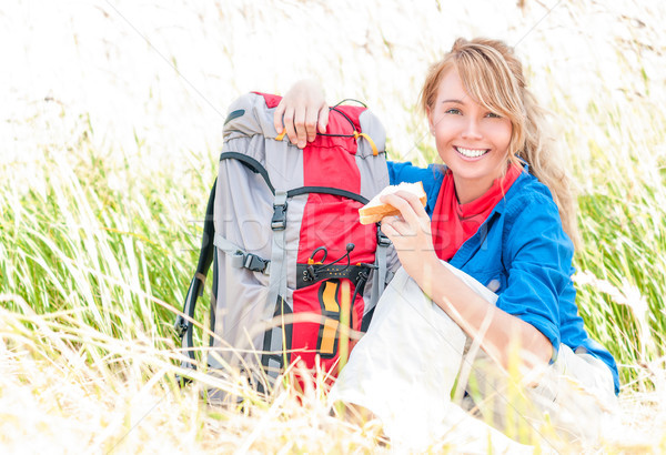 Stock photo: Young tourist woman having lunch outdoors.