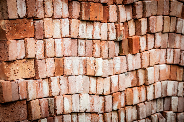 Wall of new red bricks stacked in rows. Stock photo © kyolshin