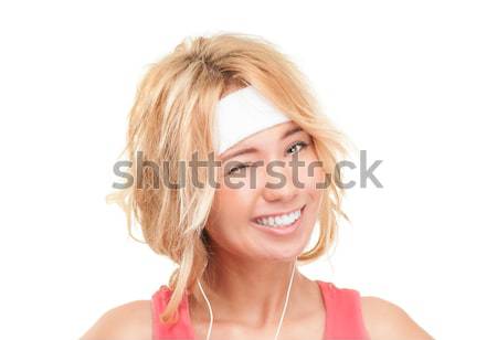 Young sporty woman winking on white background. Stock photo © kyolshin