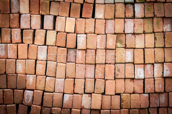 Wall of new red bricks stacked in rows. Stock photo © kyolshin