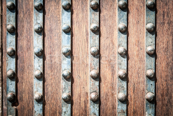 Detail of wood and metal door with rivets. Stock photo © kyolshin