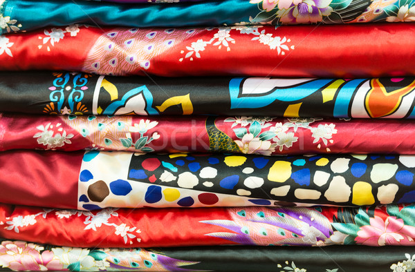 Pile of silk clothes with abstract asian design. Stock photo © kyolshin