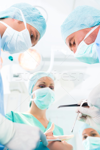 Surgeons operating in operation theater room Stock photo © Kzenon