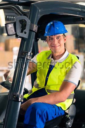 Builder driving site pallet transporter or lift fork truck Stock photo © Kzenon