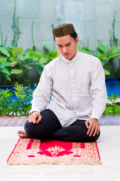 Asian Muslim man praying on carpet Stock photo © Kzenon