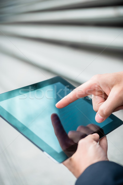 Stock photo: Businessman using a tablet touchscreen