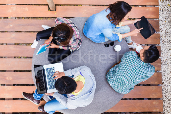 Young employees using modern wireless technology while working o Stock photo © Kzenon