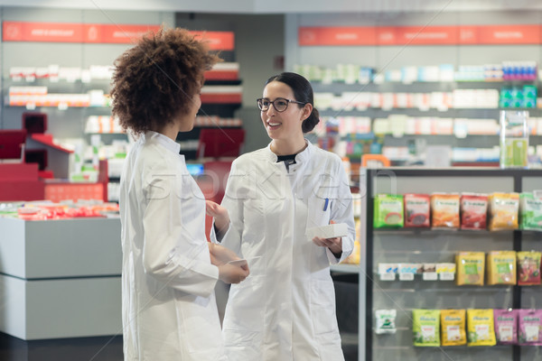 Two friendly colleagues talking while working together as pharmacists Stock photo © Kzenon