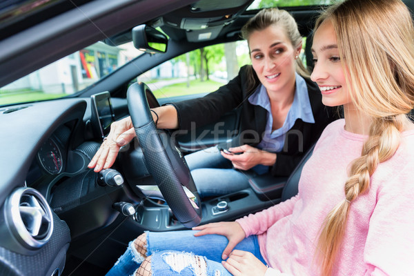 Student on wheel of car in driving lesson with her teacher Stock photo © Kzenon