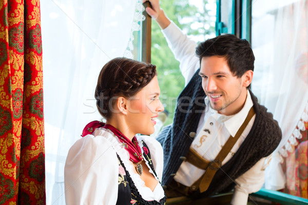 Young couple on the window of a hunter's cabin Stock photo © Kzenon