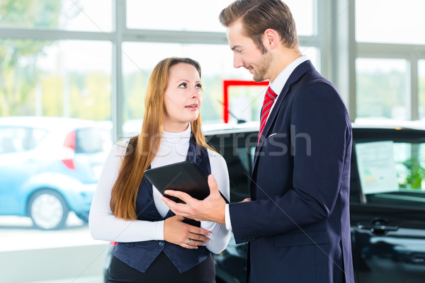 Dealer, female client and auto in car dealership Stock photo © Kzenon