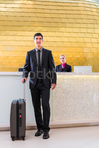 Man departing on business trip at hotel reception  Stock photo © Kzenon
