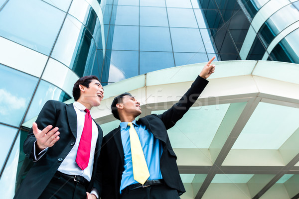 Asian businesspeople in front of high rise building  Stock photo © Kzenon