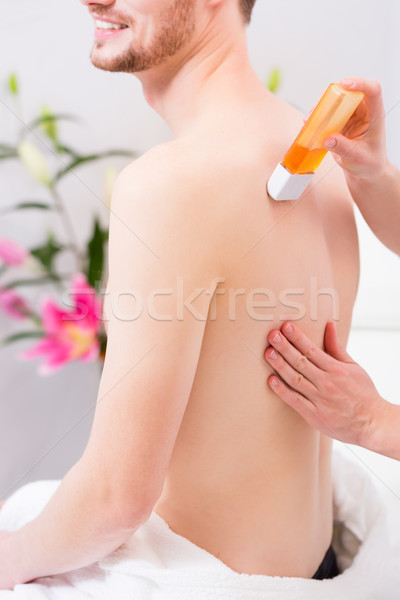 man at waxing hair removal in beauty parlor Stock photo © Kzenon