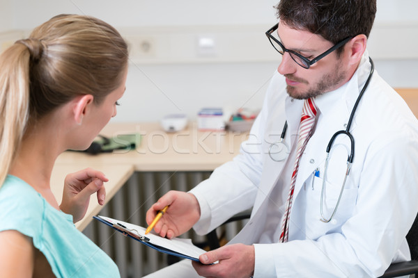 Pregnant woman seeing doctor for checkup Stock photo © Kzenon
