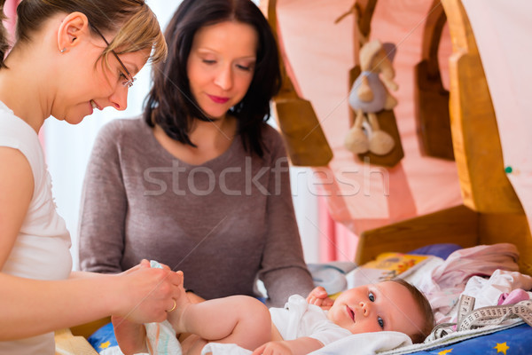 Midwife examining newborn baby Stock photo © Kzenon