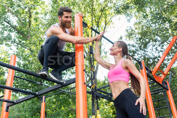 Beautiful fit woman giving high-five to her workout partner Stock photo © Kzenon