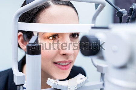 Woman having eyes measured with test device Stock photo © Kzenon