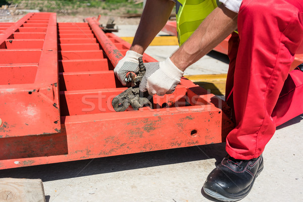 Worker installing metallic framing while working Stock photo © Kzenon